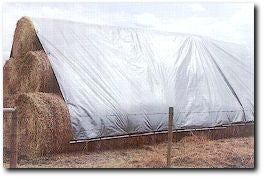hay stack covered with a hay tarp